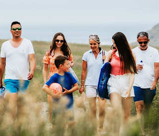 A family enjoying a peaceful stroll to the Cornish coastline on a summers day.