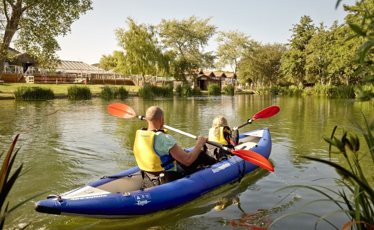 A father and daughter kayaking through the lake at one of our static caravan holiday parks, The Lakes Rookley. image