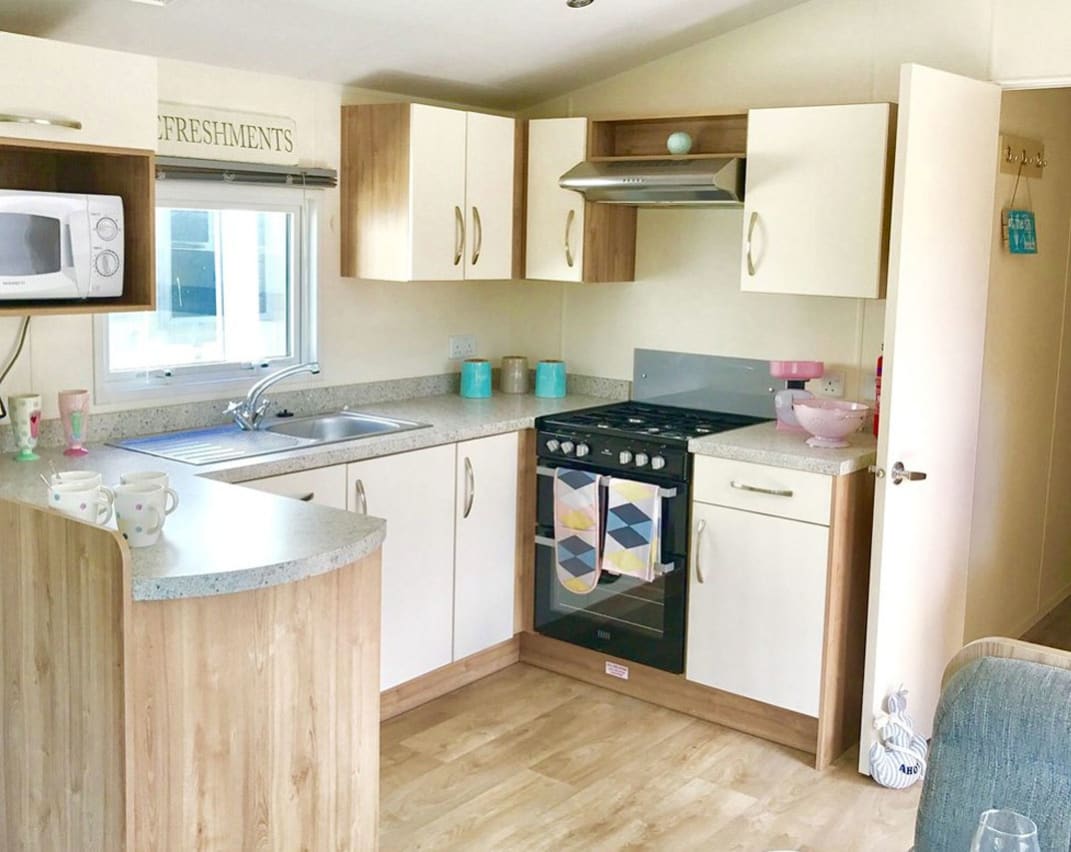 The kitchen area of our bright and spacious superior static caravan. The perfect way to stay.