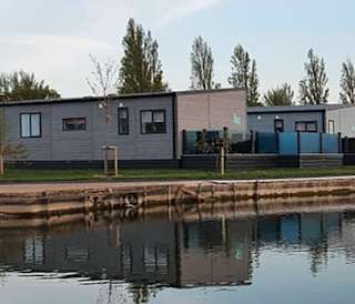 A view of our stunning holiday homes over the lake at Mill Rythe, Hampshire.
