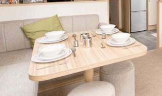 The living and dining area of our bright and spacious comfort static caravan. The perfect way to stay. image