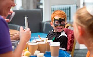 Two young children enjoying one of our awesome on-site activities, the Superhero Academy. image
