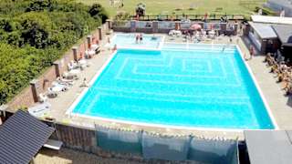 A hot summer's day overlooking our outdoor pool at Whitecliff Bay. Come see for yourself when you visit the Isle of Wight on your next caravan holiday.