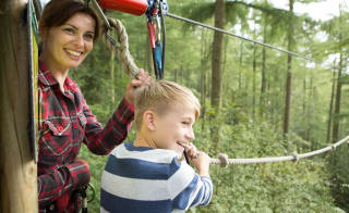 A young boy and female enjoying a day at Go Ape. image