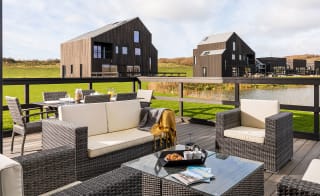 Exterior of barn area at Retallack Resort and Spa overlooking the lake and beautiful Cornish countryside. image