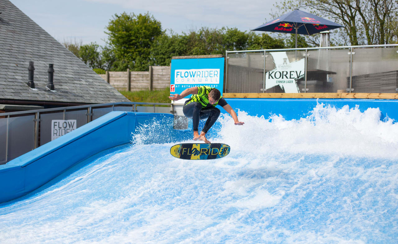 A man performing on our Retallack Resort and Spa FlowRider surfing machine. image