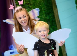 Young child participating in the Fairy Academy activity. image