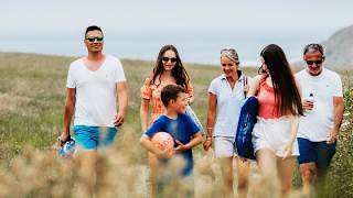 A family enjoying a peaceful stroll to the Cornish coastline on a summers day.