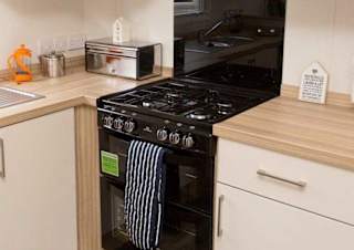The kitchen area of our bright and spacious comfort static caravan. The perfect way to stay.
