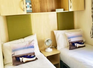 The twin bedroom in our bright and spacious superior static caravan. The perfect way to stay. image