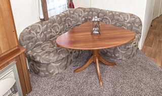 The dining area of our budget-friendly value static caravan. The perfect way to stay. image