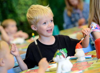 A young boy pottery painting at one of our Away Resorts holiday parks. image