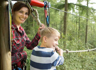 A young boy and female enjoying a day at Go Ape. image