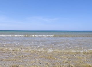 Rolling waves on a bright summers day at a lagoon in Dorset. image