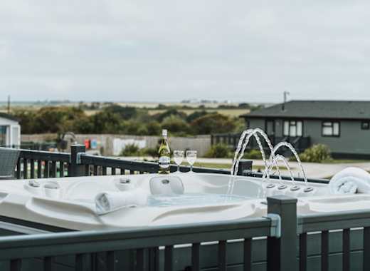 One of our stunning accommodations with a hot tub and a bottle of bubbly, relaxation at it's finest!