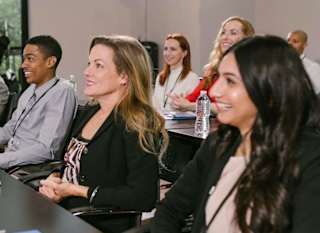 A group of people attending a conference meeting. image