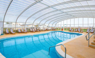 One of our spacious indoor swimming pools with a glass archway roof. Located at our holiday park in Mersea Island, Essex. image