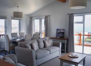 The living area of our bright and spacious Superior Lodge with stunning seaviews. The perfect way to stay. image