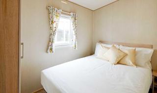 The double bedroom in our bright and spacious comfort static caravan. The perfect way to stay. image