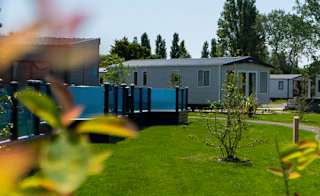 Our Mill Rythe holiday park.There are plenty of static caravans surrounding a lake, with lots of spacious green areas nearby. image