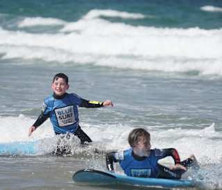 Two young boys enjoying their surf at Blue Surf School.