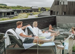 Friends chilling in the rooftop hot tub at Retallack Resort and spa. image