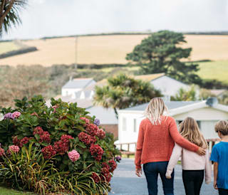 Family walking through Newquay Bay Holiday Park.