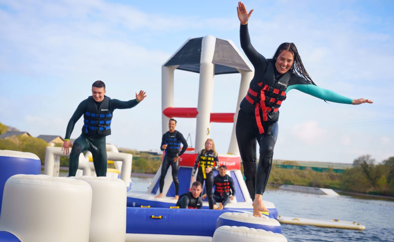 A group of young adults enjoying a fun-filled day out at Retallack Resort & Spa, Cornwall, in our awesome aqua park. image