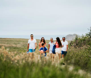 A family enjoying a peaceful stroll to the Cornish coastline on a summers day.