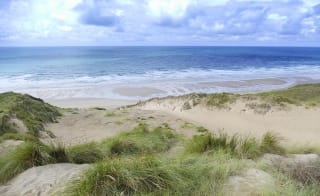An image of the beach and sea from the South West Coastal Path. image