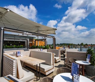 An image of an outdoor seating area on a balconey looking out to the river at one of our holiday parks.