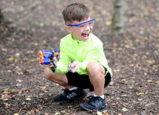 A young boy participating in our Nerf Challenge activity. image