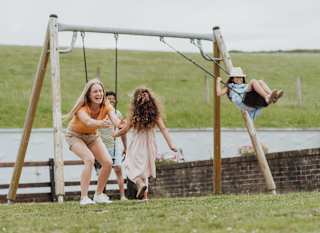 Family enjoying our playground area ta Newquay Bay Holiday Park. image