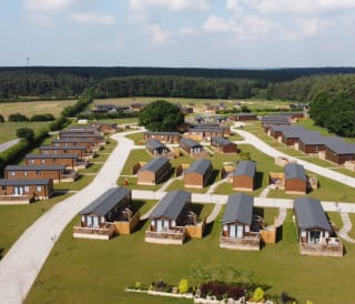 Drone footage above our stunning resort Clumber Park, Nottinghamshire. There are rows of wooden holiday homes perched within stunning woodland scenery.