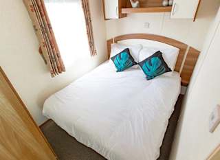 The double bedroom of our budget-friendly value static caravan. The perfect way to stay. image