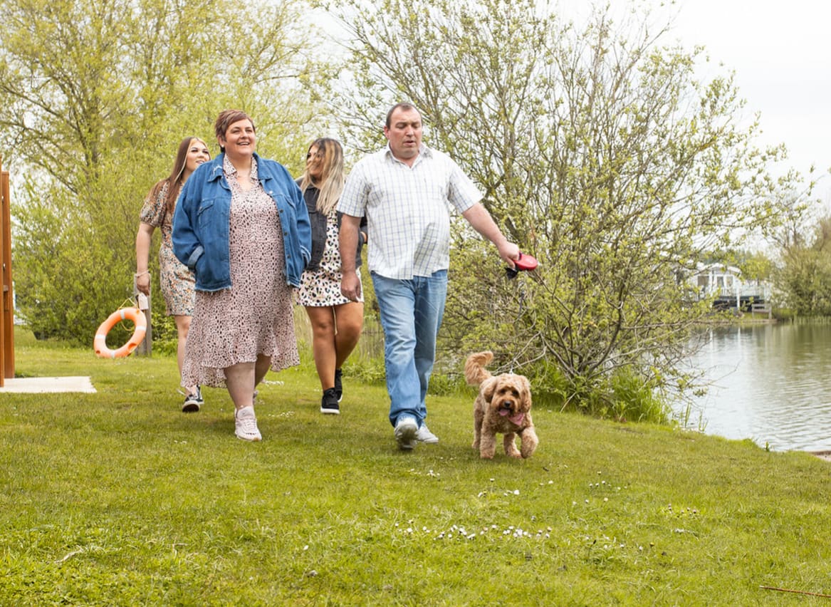 Family out walking their dog by the lake, what a great way to spend ownership days at Tattershall Lakes. image