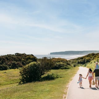 A young family walking to the beach, a stones throw away from our stunning Yorkshire resort, The Bay Filey. image