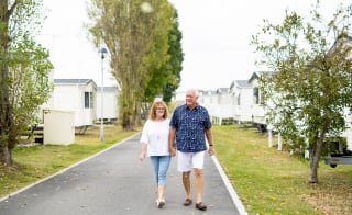 A couple walking through one of our holiday parks. image