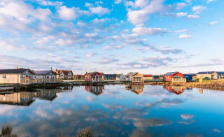 Holiday lodges looking out to a lake at The Bay Filey, Yorkshire, Away Resorts. image