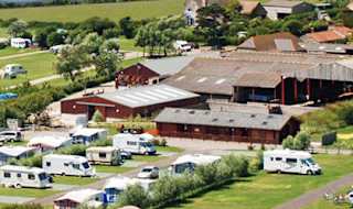 A drone image of our camping and touring park in Dorset, East Fleet Farm with views of the lagoon. image