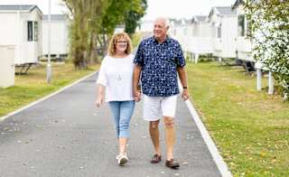 A couple walking through one of our holiday parks. image