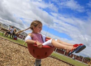 A child playing in the outdoor play area at our holiday park in North Wales, Golden Sands. image