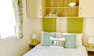 The double bedroom in our bright and spacious superior static caravan. The perfect way to stay. image