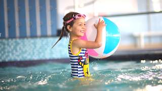 A young girl playing in a indoor pool at our caravan holiday park Golden Sands, North Wales.