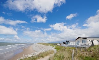 A sunny, cloudy day overlooking the beach at Barmouth Bay, North Wales. Book now to stay in one of our luxury static caravans. image