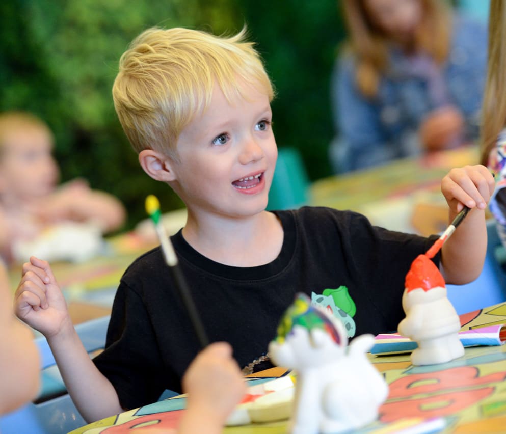 A young boy pottery painting at one of our Away Resorts holiday parks.