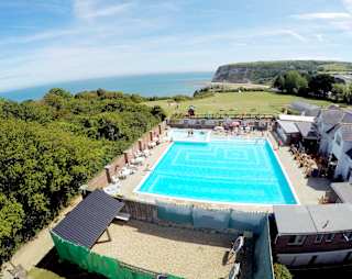 A hot summer's day overlooking our outdoor pool at Whitecliff Bay. Come see for yourself when you visit the Isle of Wight on your next caravan holiday.