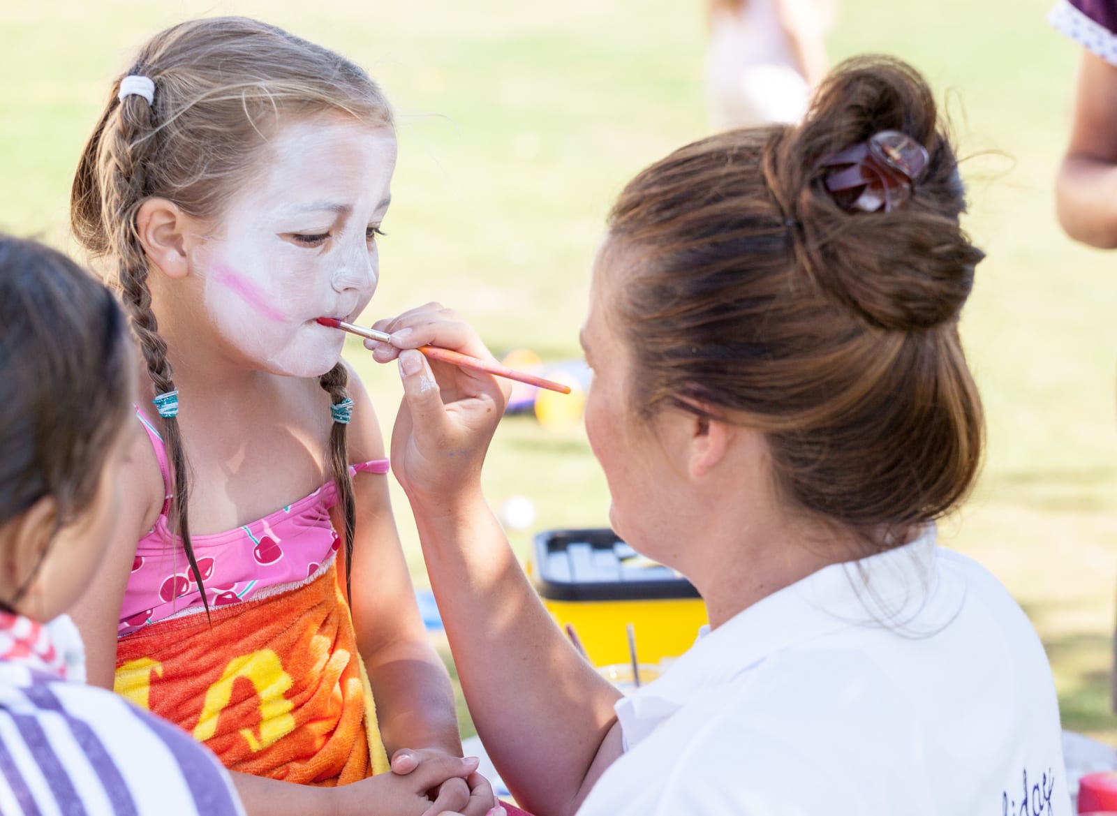 A child getting their face painted. image