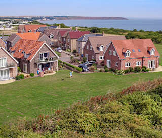 A drone image over the accommodation at The Bay Filey with views of the sea in the background.