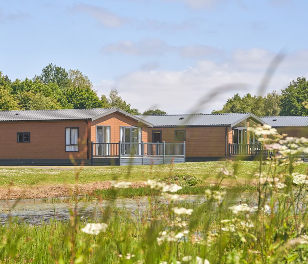 Over lake view of our lodges available to holiday at, Appletree Holiday Park.